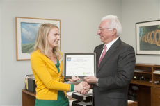 Ms. Amy Marquardt, PhD candidate in the Department of Materials Science and Engineering, receives the 2014 U21 3MT award from Dr. Charles Caramello, Dean of the Graduate School. Photo by Thai Nguyen.